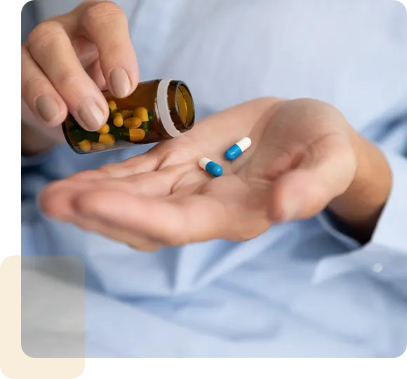 Elderly sick ill woman hold two pills on hand pouring capsules from medication bottle take painkiller supplement medicine