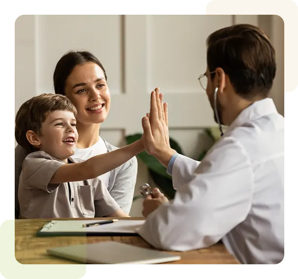 Child giving a high five to a doctor
